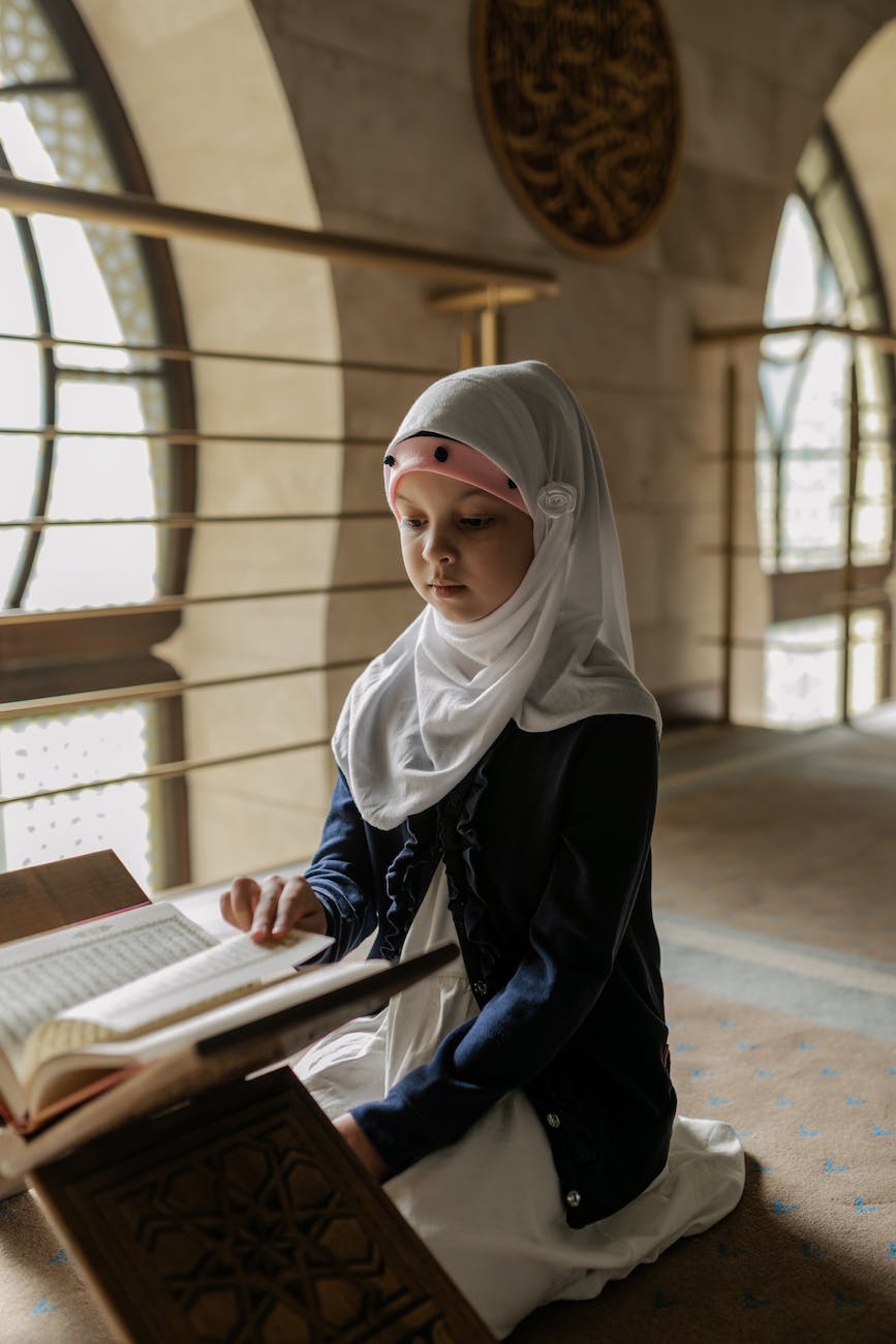 Two Muslim girls reading a holy book Quran inside the mosque. Stock Photo |  Adobe Stock